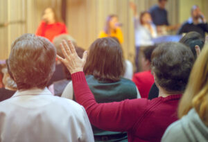 Men and women participating in worship at church service