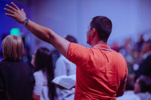 man worshipping in church