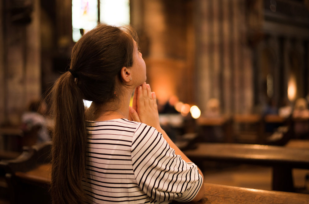 woman praying in church