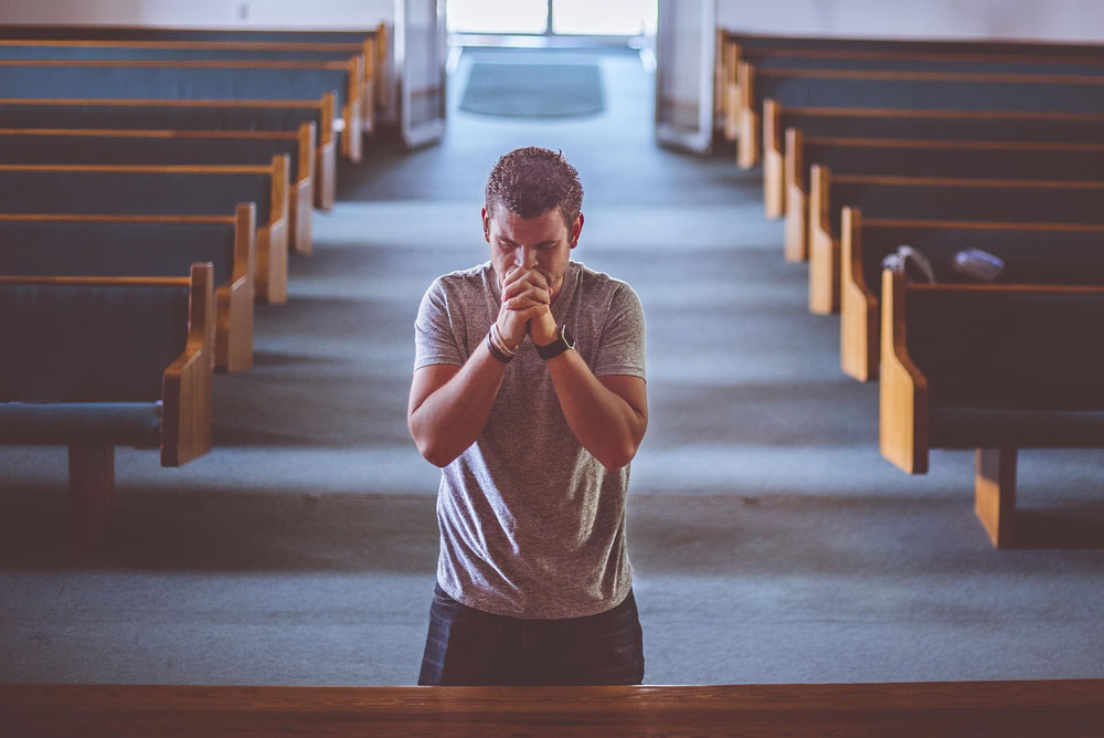 man praying in church